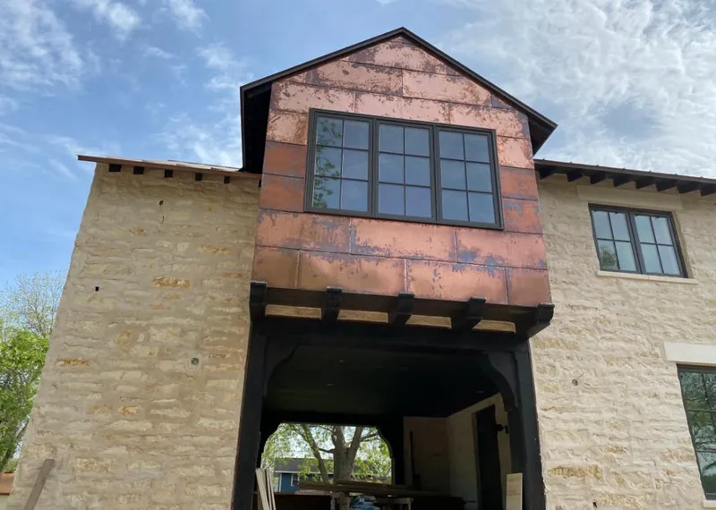 Copper metal panel facade on a stone building for Skylight Installation in Whitman